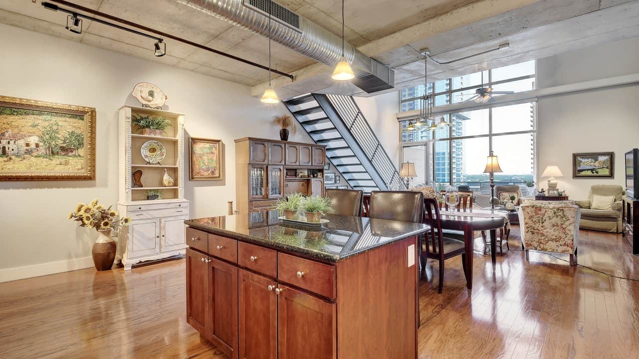 kitchen island hard wood floors windows view stairs austin city lofts downtown condo