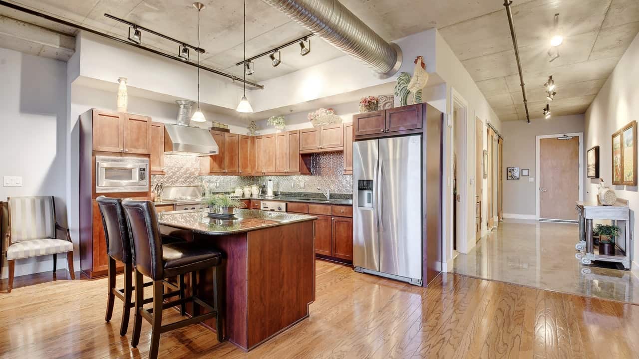 wood flooring kitchen island stainless steel austin city lofts downtown condo