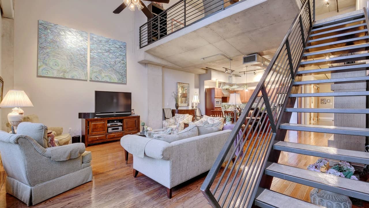 stairs two story loft wood floors living room austin city lofts downtown condo