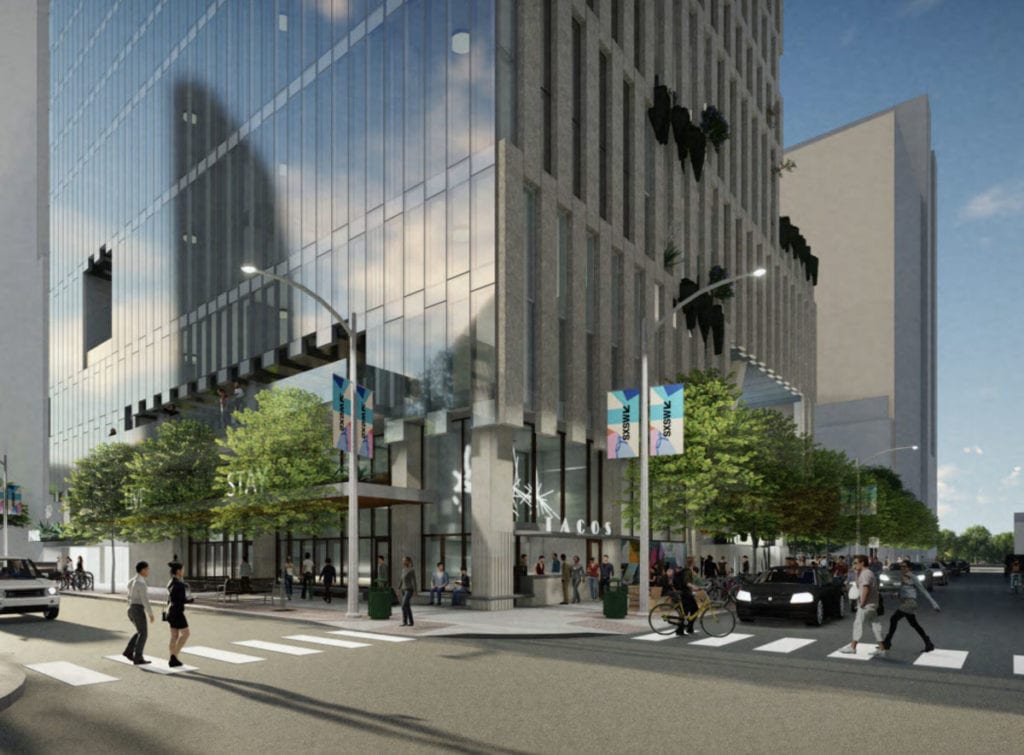 Modern city street corner with a glass office building and people crossing a busy intersection