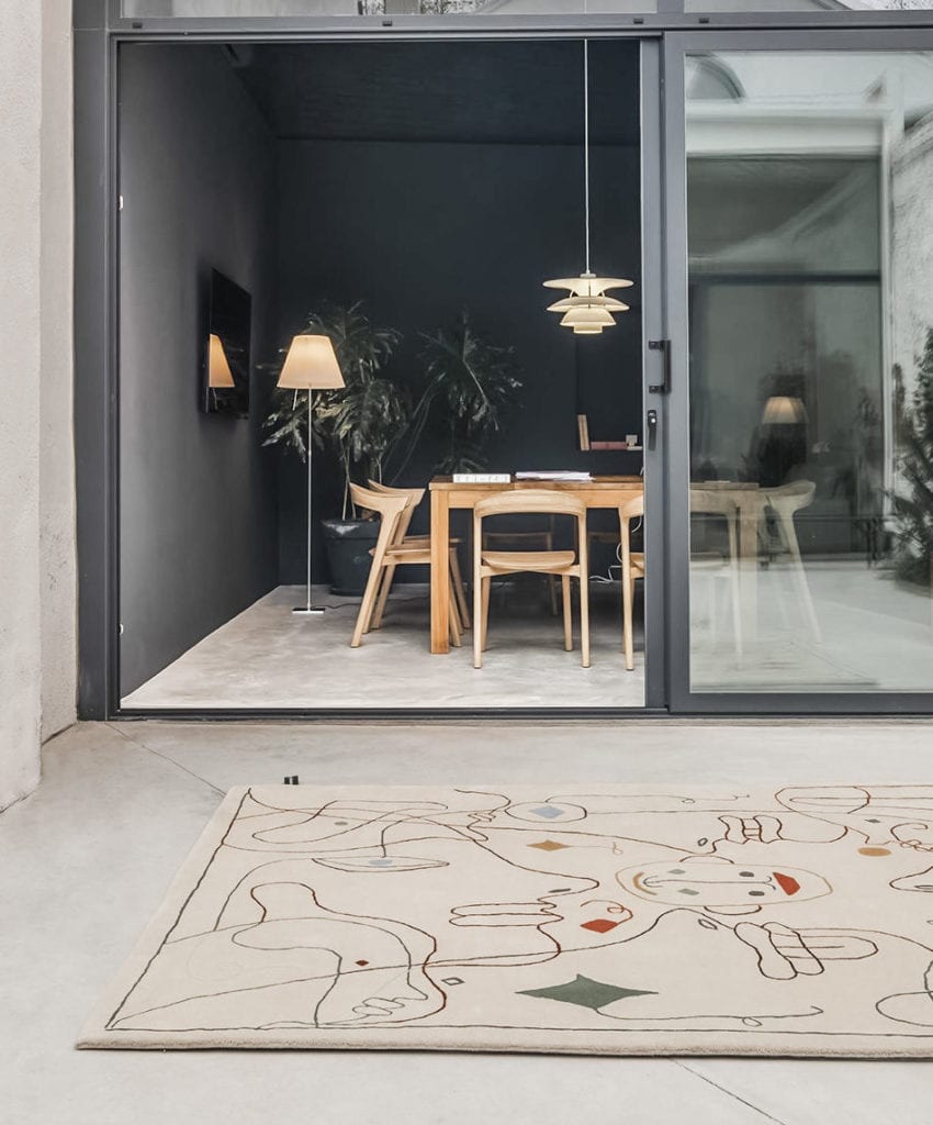 Modern dining room with glass doors and abstract patterned rug